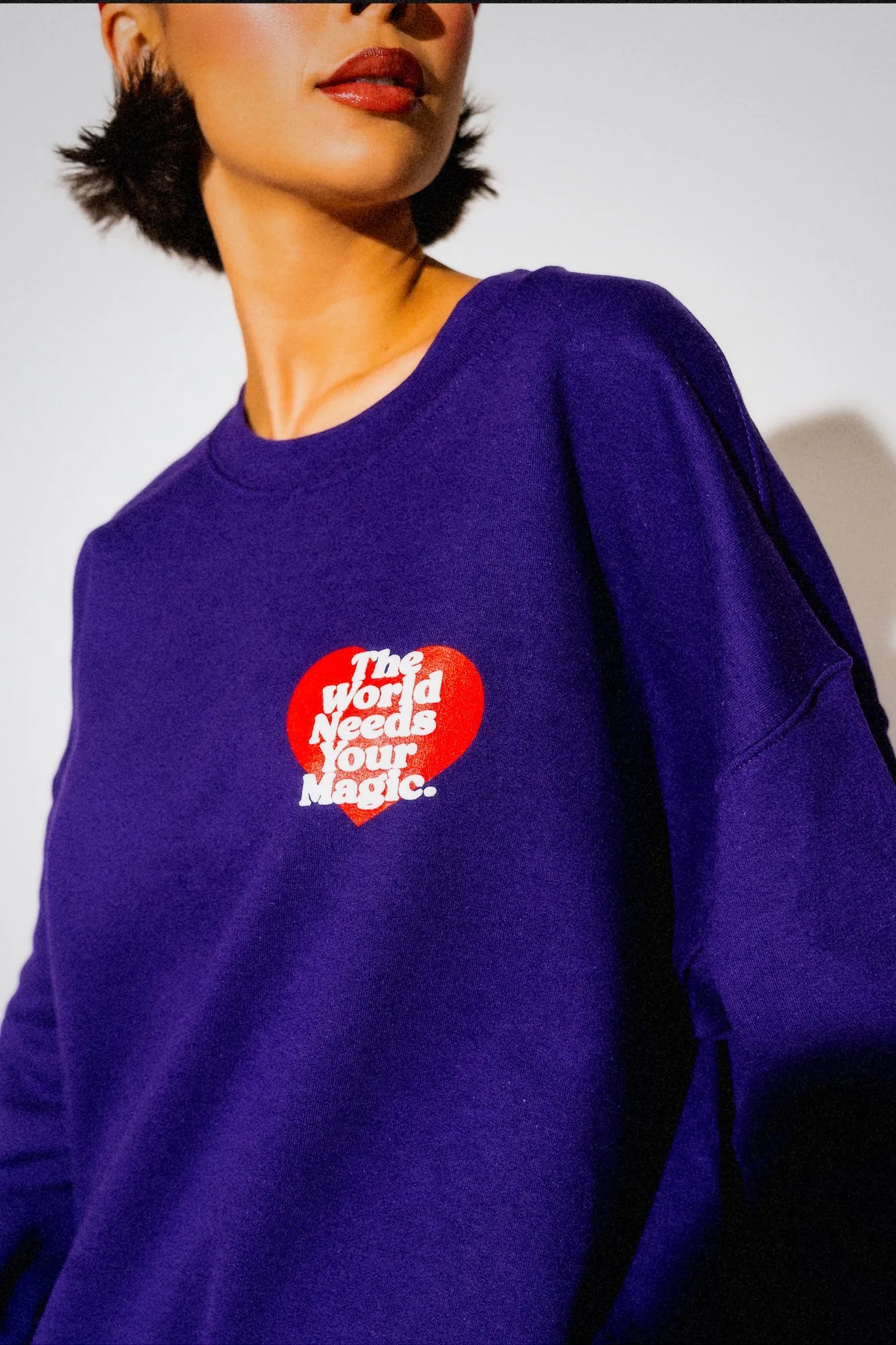 The World Needs Your Magic Heart Puff Print Pullover in Grape Soda